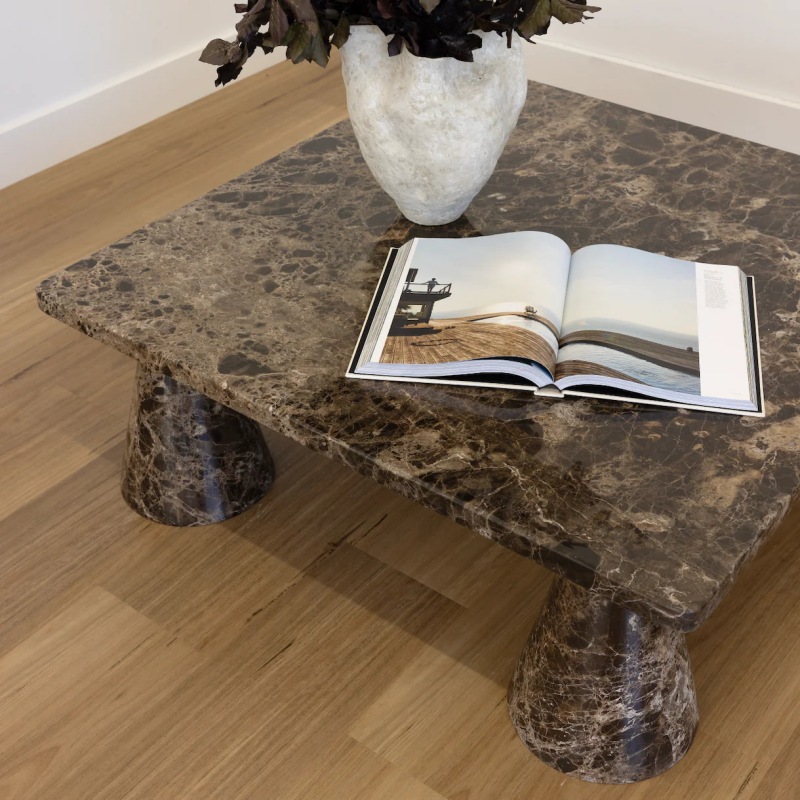 Dark brown veined marble coffee table with flared stone bases