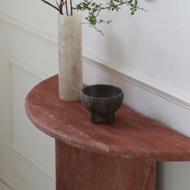 Close-up of Travertine Red marble texture on half-moon console table - natural stone detail