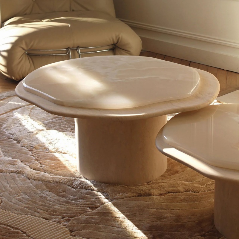White Onyx Cloud-Shaped Coffee Table with cylindrical base - styled in sunlit living room with beige sofa