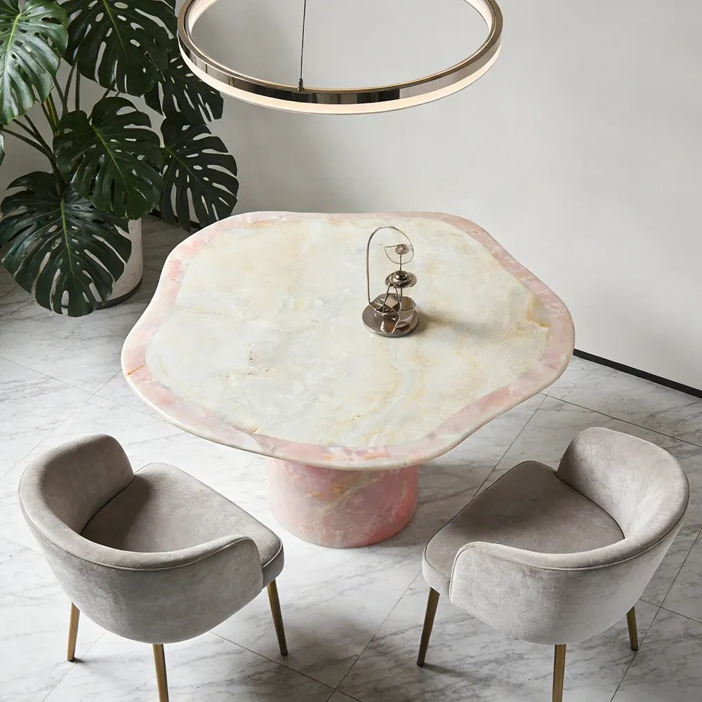 Natural pink onyx round‑freeform table with glowing translucent stone texture